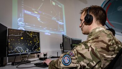 Soldier operating a command, control, and command, control, and data processing station for military satellites