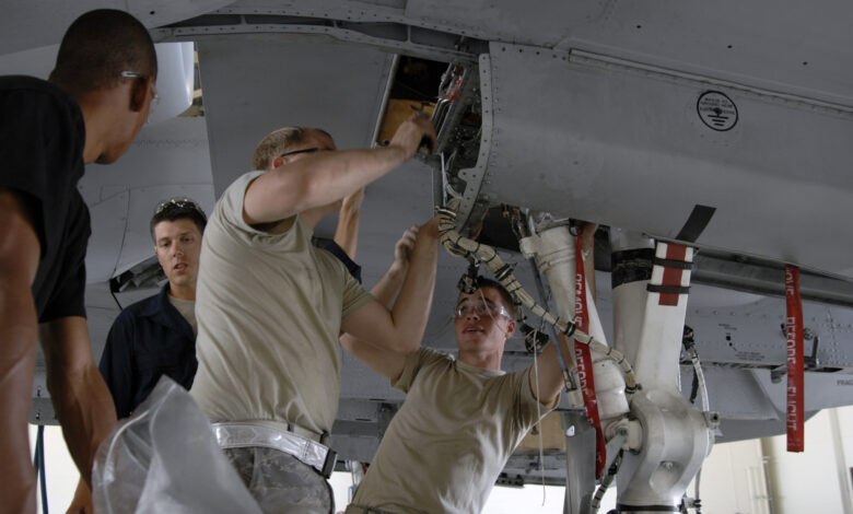 Maintainers at Moody Air Force Base prepare to inspect an A-10 Thunderbolt II for wing frame cracks