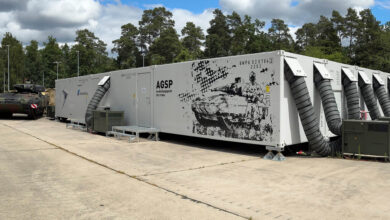 Infantry Fighting Vehicle Puma beside Rheinmetall's mechanized vehicle simulator