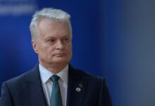 Lithuania President Gitanas Nauseda arriving at EU summit with blue background