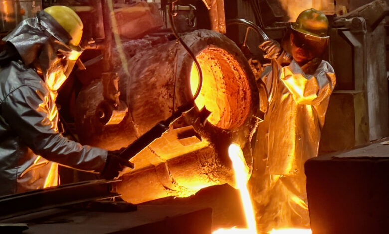 Foundry artisans fill a mold to manufacture cast parts at Stainless Foundry and Engineering in Wisconsin