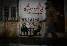 A mural titled 'Divided by Oligarchy' by anonymous Norwegian street artist Toddel, depicting US President Donald Trump and Russian President Vladimir Putin seated at a table next to a map of a divided Ukraine, is seen on a wall in Krakow, Poland, on January 29, 2026.