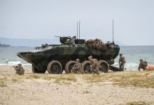 US Marines egress an Amphibious Combat Vehicle to secure the beach at Hwajin-ri, South Korea, during a simulated amphibious assault