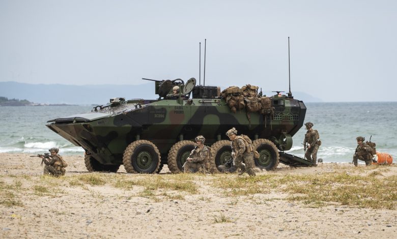 US Marines egress an Amphibious Combat Vehicle to secure the beach at Hwajin-ri, South Korea, during a simulated amphibious assault