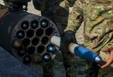 A U.S. Army Soldier assigned to the 12th Combat Aviation Brigade load an Advanced Precision Kill Weapon System (APKWS) training round for a live-fire exercise, Sept. 23, 2021, Grafenwoehr Training Area, Germany. The APKWS is the newest laser-guided rocket system utilized by the 12th CAB stationed throughout Europe. (U.S. Army photo by Pfc. Jesus Menchaca)