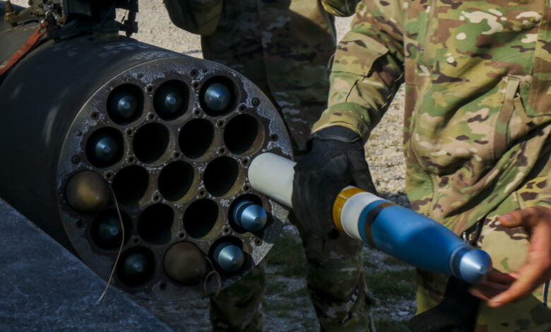 A U.S. Army Soldier assigned to the 12th Combat Aviation Brigade load an Advanced Precision Kill Weapon System (APKWS) training round for a live-fire exercise, Sept. 23, 2021, Grafenwoehr Training Area, Germany. The APKWS is the newest laser-guided rocket system utilized by the 12th CAB stationed throughout Europe. (U.S. Army photo by Pfc. Jesus Menchaca)