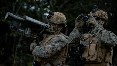 U.S. Marine Corps Cpl. Mario Infante, left, and Cpl. Jayden Spear, both gunners with 1st Low Altitude Air Defense Battalion, 1st Marine Air Wing, rehearse engaging drones on Camp Schwab, Okinawa, Japan, March 11, 2026. U.S. Marines with 1st LAAD and 4th Marine Regiment drone operators conducted integrated training, allowing both units to mutually enhance their anti-aircraft and aerial surveillance capabilities. Infante and Spear are both natives of Florida. (U.S. Marine Corps photo by Cpl. Joaquin Dela Torre)