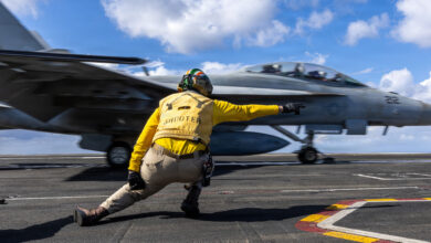 A U.S. Sailor signals the launch of an F/A-18F Super Hornet aircraft, attached to Strike Fighter Squadron 213, on the flight deck of the world’s largest aircraft carrier, USS Gerald R. Ford (CVN 78), while underway in the Eastern Mediterranean Sea March 22, 2026. Gerald R. Ford is on a scheduled deployment in the U.S. 6th Fleet area of operations to support the warfighting effectiveness, lethality and readiness of U.S. Naval Forces Europe Africa, and defend U.S., Allied and partner interests in the region. (U.S. Navy photo by Mass Communication Specialist Seaman Apprentice India AaronTerrell)