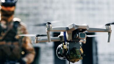 A soldier launches an armed drone.