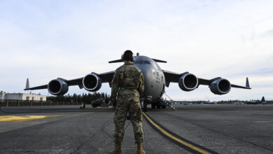US Air Force troop, 62nd Aircraft Maintenance Squadron crew chief, communicates with the pilots on a C-17 Globemaster III in preparation for an airlift mission as part of Exercise Rainier War at Joint Base Lewis-McChord, Washington, April 28, 2021.