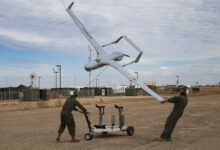 U.S. Marine Corps Lance Cpl. Isaiah Trujillo, an unmanned aircraft system (UAS) maintenance technician with Marine Unmanned Aerial Vehicle Squadron (VMU) 3, Marine Aircraft Group (MAG) 24, 1st Marine Aircraft Wing (MAW), and Lance Cpl. Mario Mendoza, a UAS maintenance technician with VMU-1, MAG-13, 3rd MAW, recover a U.S. Marine Corps RQ-21A Blackjack aircraft during Weapons and Tactics Instructor (WTI) course 1-20 at Canon Air Defense Complex in Yuma, Arizona, Sept. 26, 2019. WTI is a seven week training event hosted by Marine Aviation Weapons and Tactics Squadron One (MAWTS-1), which emphasizes operational integration of the six functions of Marine Corps Aviation in support of a Marine Air Ground Task Force. WTI also provides standardized advanced tactical training and certification of unit instructor qualifications to support Marine Aviation training and readiness, and assists in developing and employing aviation weapons and tactics. (U.S. Marine Corps photo by Cpl. Adaezia Chavez)