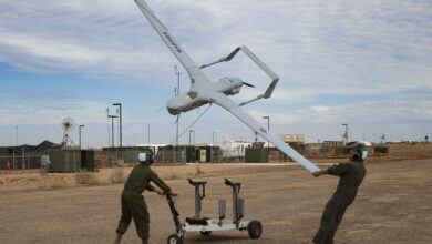 U.S. Marine Corps Lance Cpl. Isaiah Trujillo, an unmanned aircraft system (UAS) maintenance technician with Marine Unmanned Aerial Vehicle Squadron (VMU) 3, Marine Aircraft Group (MAG) 24, 1st Marine Aircraft Wing (MAW), and Lance Cpl. Mario Mendoza, a UAS maintenance technician with VMU-1, MAG-13, 3rd MAW, recover a U.S. Marine Corps RQ-21A Blackjack aircraft during Weapons and Tactics Instructor (WTI) course 1-20 at Canon Air Defense Complex in Yuma, Arizona, Sept. 26, 2019. WTI is a seven week training event hosted by Marine Aviation Weapons and Tactics Squadron One (MAWTS-1), which emphasizes operational integration of the six functions of Marine Corps Aviation in support of a Marine Air Ground Task Force. WTI also provides standardized advanced tactical training and certification of unit instructor qualifications to support Marine Aviation training and readiness, and assists in developing and employing aviation weapons and tactics. (U.S. Marine Corps photo by Cpl. Adaezia Chavez)