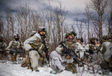 U.S. Soldiers, assigned to 1st Battalion, 5th Infantry Regiment, 1st Infantry Brigade Combat Team, 11th Airborne Division, observe the upcoming landscape for a night troop movement during Joint Pacific Multinational Readiness Center 24-02 at Donnelly Training Area, Alaska, Feb. 18, 2024.The Arctic is unforgiving and requires deliberate, purposeful leaders who are meticulous in their planning and approach to warfighting, and JPMRC 24-02 is key to testing some of the best leaders and soldiers the Army has to offer. (U.S. Army photo by Pfc. Elijah Magaña)