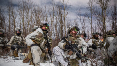 U.S. Soldiers, assigned to 1st Battalion, 5th Infantry Regiment, 1st Infantry Brigade Combat Team, 11th Airborne Division, observe the upcoming landscape for a night troop movement during Joint Pacific Multinational Readiness Center 24-02 at Donnelly Training Area, Alaska, Feb. 18, 2024.The Arctic is unforgiving and requires deliberate, purposeful leaders who are meticulous in their planning and approach to warfighting, and JPMRC 24-02 is key to testing some of the best leaders and soldiers the Army has to offer. (U.S. Army photo by Pfc. Elijah Magaña)