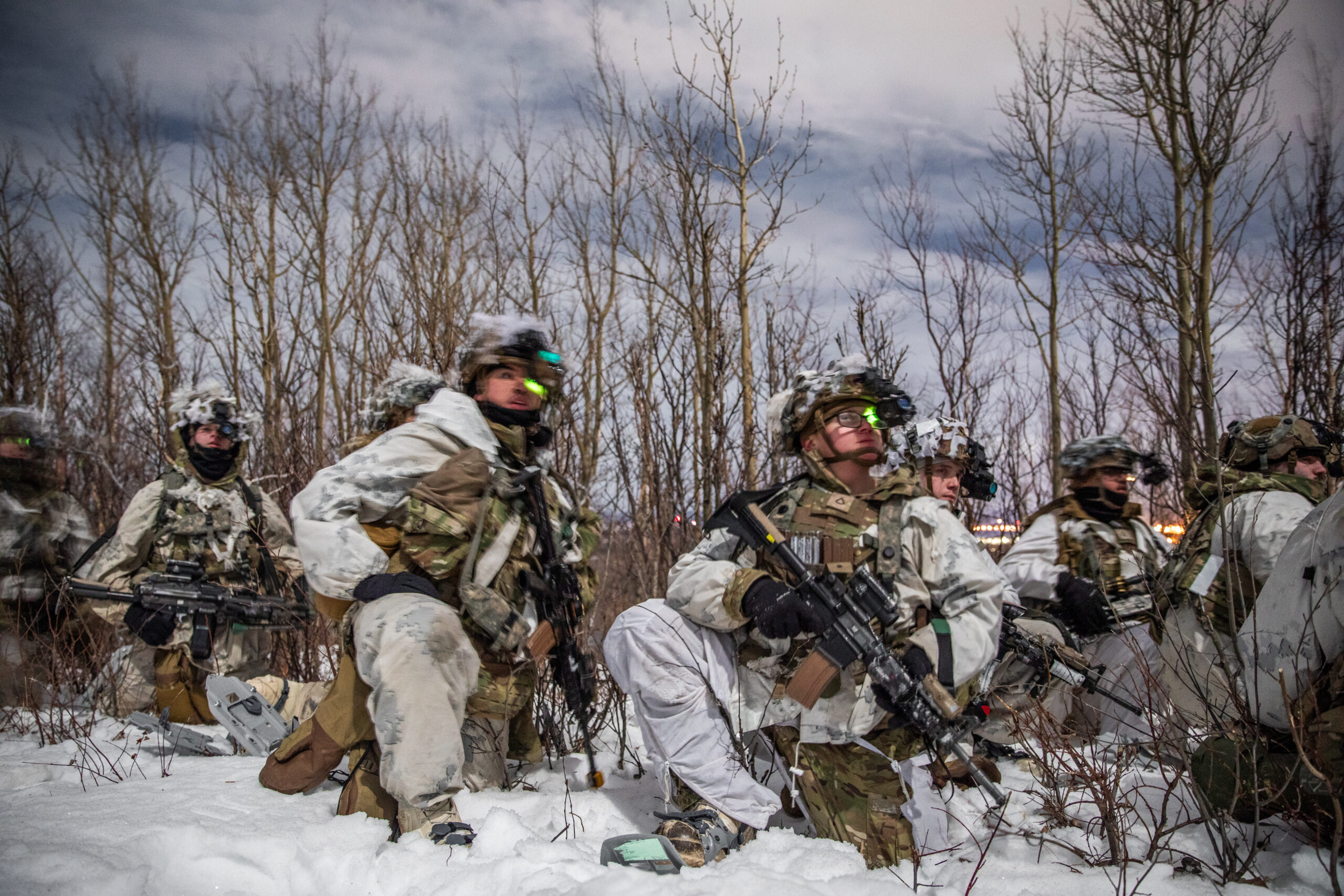 U.S. Soldiers, assigned to 1st Battalion, 5th Infantry Regiment, 1st Infantry Brigade Combat Team, 11th Airborne Division, observe the upcoming landscape for a night troop movement during Joint Pacific Multinational Readiness Center 24-02 at Donnelly Training Area, Alaska, Feb. 18, 2024.The Arctic is unforgiving and requires deliberate, purposeful leaders who are meticulous in their planning and approach to warfighting, and JPMRC 24-02 is key to testing some of the best leaders and soldiers the Army has to offer. (U.S. Army photo by Pfc. Elijah Magaña)
