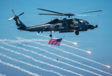 U.S. Navy MH-60R Seahawk helicopter, assigned to Helicopter Maritime Strike Squadron (HSM) 75, shoots flares while flying over the flight deck of Nimitz-class aircraft carrier USS Theodore Roosevelt (CVN) 71 during a friends and family day cruise, Aug. 8, 2026. Theodore Roosevelt’s friends and family day cruise showcases carrier strike group capabilities and the professionalism of the crew. (U.S. Navy photo by Mass Communication Specialist Seaman Tyler Harstad)