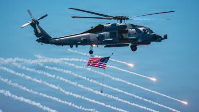 U.S. Navy MH-60R Seahawk helicopter, assigned to Helicopter Maritime Strike Squadron (HSM) 75, shoots flares while flying over the flight deck of Nimitz-class aircraft carrier USS Theodore Roosevelt (CVN) 71 during a friends and family day cruise, Aug. 8, 2026. Theodore Roosevelt’s friends and family day cruise showcases carrier strike group capabilities and the professionalism of the crew. (U.S. Navy photo by Mass Communication Specialist Seaman Tyler Harstad)