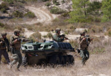 Dismounted troops operating with the Mission Master unmanned ground vehicle
