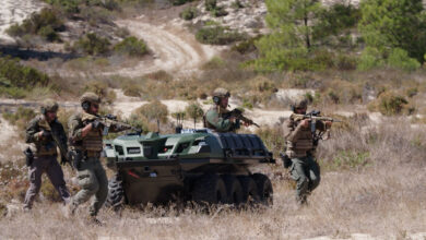 Dismounted troops operating with the Mission Master unmanned ground vehicle