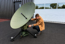 Program Manager Rich Steixner with the Lite Coms LITE SAT 1.3A terminal supporting the ADF LAND 4140 LAND C4 Modernization program.