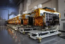 Row of T1TL satellites in a warehouse.