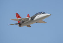 The first T-7A Red Hawk, piloted by USAF test pilot Maj. Jonathan “Gremlin” Aronoff and Boeing test pilot Steve “Bull” Schmidt, soars over Edwards Air Force Base, California, Nov. 8, prior to arrival. The T-7A will replace the 1960s-era T-38 aircraft by providing advanced pilot training capabilities for aviators learning to fly both tactical and bomber aircraft.