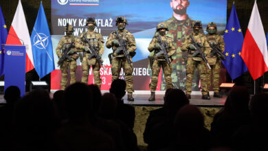 Polish soldiers show off their new uniforms during a presentation.