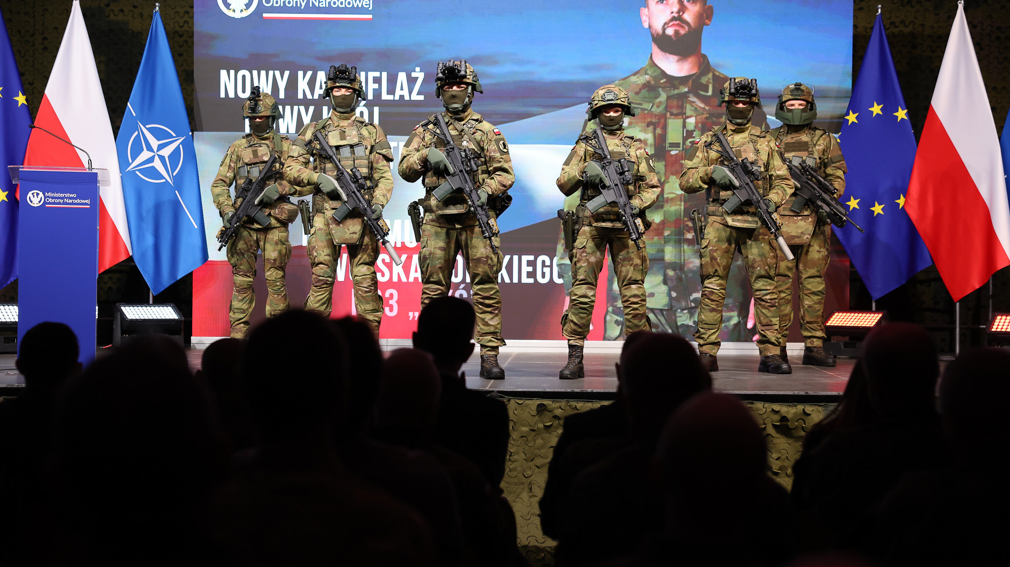 Polish soldiers show off their new uniforms during a presentation.