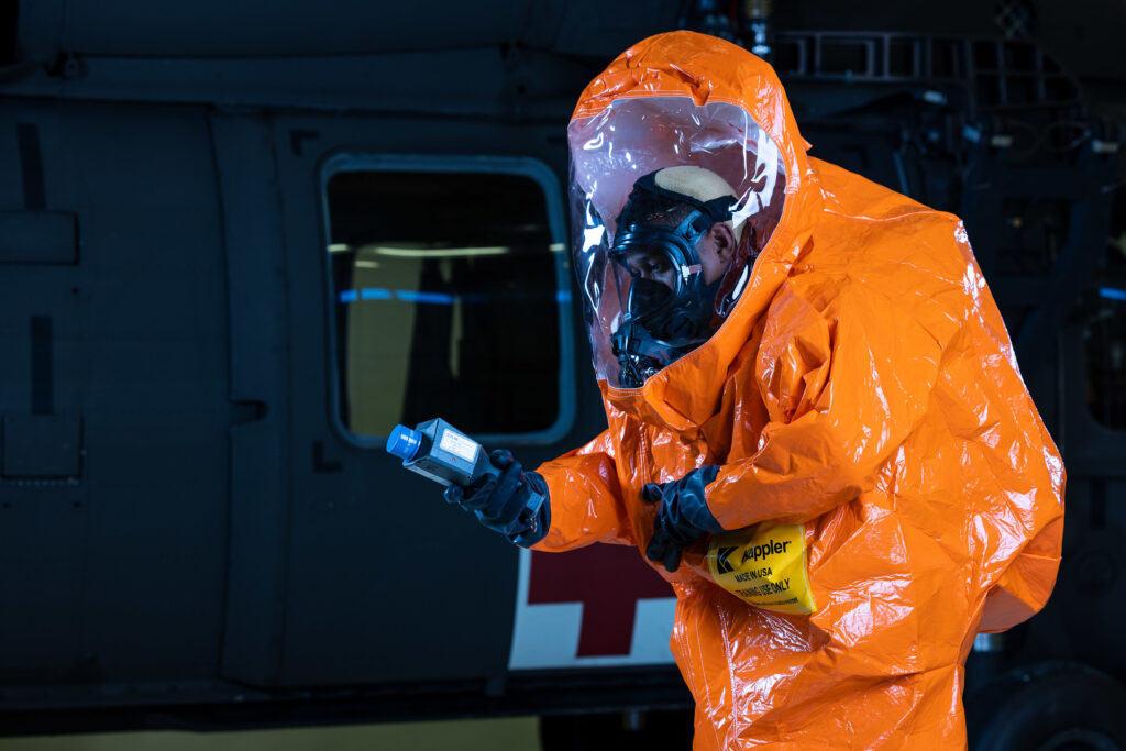 U.S. Army Staff Sgt. Jose Marquez, a survey team chief assigned to the 32nd Civil Support Team, Maryland Army National Guard, simulates a check for radiation using an Identifier while wearing a full encapsulated Level A HAZMAT training suit Oct. 21, 2022, at Aberdeen Proving Ground, Maryland. Marquez was one of several models selected to model for a photoshoot highlighting Army National Guard Soldiers occupational specialties for the upcoming Health of the Force report. (U.S. Army photo by Graham Snodgrass)
