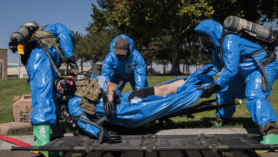 Washington National Guard explosive ordnance technicians with 319th Explosive Ordnance Company (EOD), 741st Ordnance Battalion, 96th Troop Command, transport a casualty from the incident site at the RJ Lee Group Columbia Basin analytical laboratory, in Pasco, Wash., Aug. 14, 2023. 319th EOD hosted a collaborative training exercise attended by members of the Tri-County Regional HAZMAT Team, a specialty organization comprised of fire departments within the Southeast quarter of Washington State. The training scenario focused on strengthening communication and building relationships between the National Guard and community responders. (U.S. Army National Guard photo by Staff Sgt. Adeline Witherspoon)