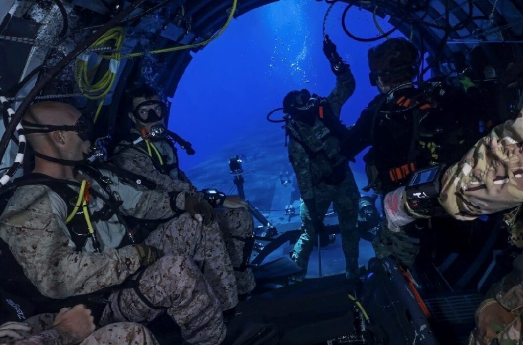 MEDITERRANEAN SEA (July 31, 2024) U.S. Marines from the 2nd Force Reconnaissance Company, assigned to Task Force 61/2, conduct dive training out of the dry deck shelter of Ohio-class guided-missile submarine USS Georgia (SSGN 729) while underway in the Mediterranean Sea July 31, 2024. Headquartered in Naples, Italy, U.S. Naval Forces Europe-Africa (NAVEUR-NAVAF) operates U.S. naval forces in the U.S. European Command and U.S. Africa Command areas of responsibility. U.S. Sixth Fleet is permanently assigned to NAVEUR-NAVAF, and employs maritime forces through the full spectrum of joint and naval operations. (U.S. Navy Courtesy Photo)
