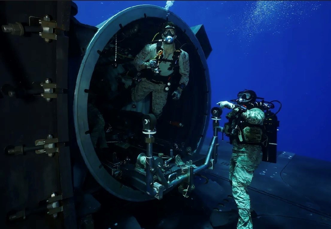 MEDITERRANEAN SEA (July 27, 2024) U.S. Marines from the 2nd Force Reconnaissance Company, assigned to Task Force 61/2, conduct dive training out of the dry deck shelter of Ohio-class guided-missile submarine USS Georgia (SSGN 729) while underway in the Mediterranean Sea July 27, 2024. Headquartered in Naples, Italy, U.S. Naval Forces Europe-Africa (NAVEUR-NAVAF) operates U.S. naval forces in the U.S. European Command and U.S. Africa Command areas of responsibility. U.S. Sixth Fleet is permanently assigned to NAVEUR-NAVAF, and employs maritime forces through the full spectrum of joint and naval operations. (U.S. Navy Courtesy Photo)