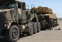A Moroccan Royal Armed Forces HET carries a U.S. Army M1A3 Abrams Tank from the 1-12 Cavalry Squadron, 1st Cavalry Division as Moroccan soldiers ensure the vehicle is properly secured and prepared for movement at the Port of Agadir, June 3, 2022, Agadir, Morocco. African Lion 2022 is U.S. Africa Command’s largest, premier, joint, annual exercise hosted by Morocco, Ghana, Senegal and Tunisia, June 6 - 30. More than 7,500 participants from 28 nations and NATO train together with a focus on enhancing readiness for U.S. and partner nation forces. AL22 is a joint all-domain, multi-component and multinational exercise, employing a full array of mission capabilities with the goal to strengthen interoperability among participants and set the theater for strategic access. (U.S. Army photo by Pfc. Donald Franklin)