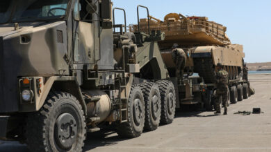A Moroccan Royal Armed Forces HET carries a U.S. Army M1A3 Abrams Tank from the 1-12 Cavalry Squadron, 1st Cavalry Division as Moroccan soldiers ensure the vehicle is properly secured and prepared for movement at the Port of Agadir, June 3, 2022, Agadir, Morocco. African Lion 2022 is U.S. Africa Command’s largest, premier, joint, annual exercise hosted by Morocco, Ghana, Senegal and Tunisia, June 6 - 30. More than 7,500 participants from 28 nations and NATO train together with a focus on enhancing readiness for U.S. and partner nation forces. AL22 is a joint all-domain, multi-component and multinational exercise, employing a full array of mission capabilities with the goal to strengthen interoperability among participants and set the theater for strategic access. (U.S. Army photo by Pfc. Donald Franklin)