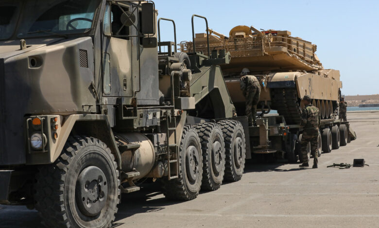A Moroccan Royal Armed Forces HET carries a U.S. Army M1A3 Abrams Tank from the 1-12 Cavalry Squadron, 1st Cavalry Division as Moroccan soldiers ensure the vehicle is properly secured and prepared for movement at the Port of Agadir, June 3, 2022, Agadir, Morocco. African Lion 2022 is U.S. Africa Command’s largest, premier, joint, annual exercise hosted by Morocco, Ghana, Senegal and Tunisia, June 6 - 30. More than 7,500 participants from 28 nations and NATO train together with a focus on enhancing readiness for U.S. and partner nation forces. AL22 is a joint all-domain, multi-component and multinational exercise, employing a full array of mission capabilities with the goal to strengthen interoperability among participants and set the theater for strategic access. (U.S. Army photo by Pfc. Donald Franklin)