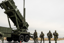 Swedish soldiers alongside a Patriot air defense system.