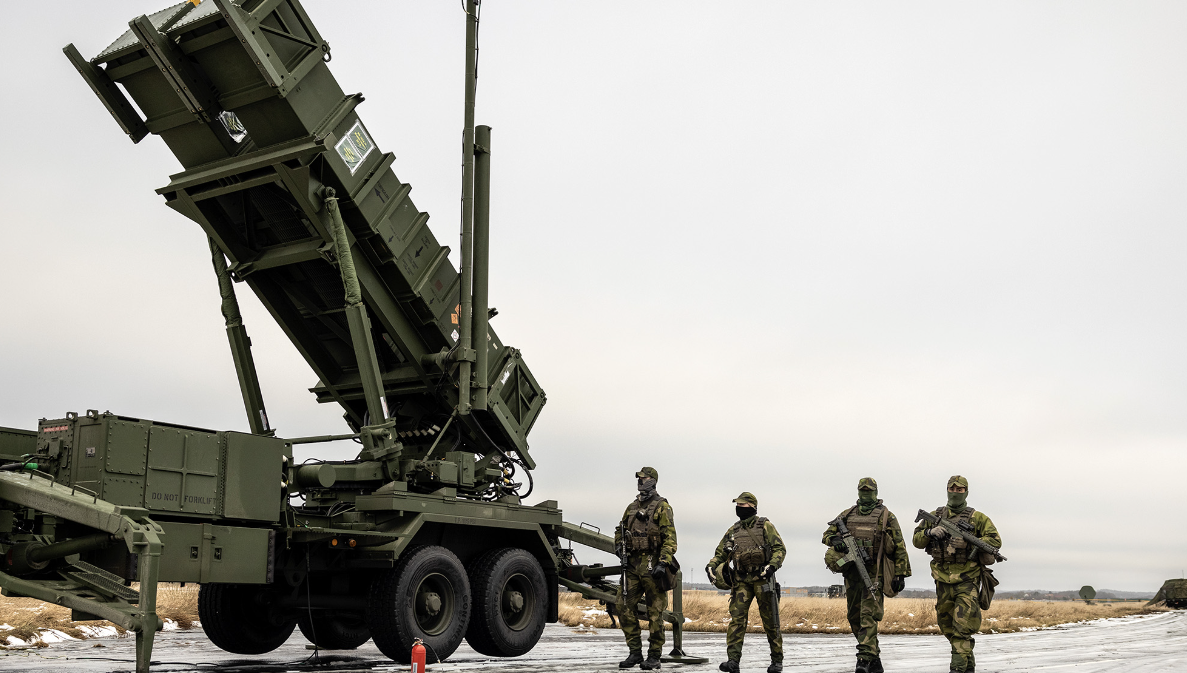Swedish soldiers alongside a Patriot air defense system.