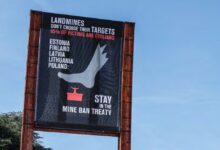 A banner on Broken Chair in front of the United Nations Office at Geneva, calling on Estonia, Finland, Latvia, Lithuania, and Poland to stay in the Mine Ban Treaty after these countries announced their intention to withdraw from the treaty.