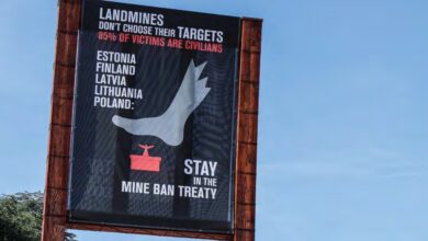 A banner on Broken Chair in front of the United Nations Office at Geneva, calling on Estonia, Finland, Latvia, Lithuania, and Poland to stay in the Mine Ban Treaty after these countries announced their intention to withdraw from the treaty.