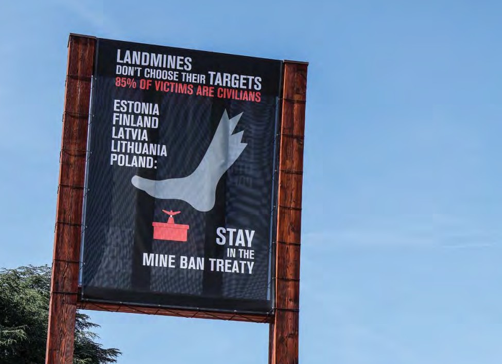 A banner on Broken Chair in front of the United Nations Office at Geneva, calling on Estonia, Finland, Latvia, Lithuania, and Poland to stay in the Mine Ban Treaty after these countries announced their intention to withdraw from the treaty.